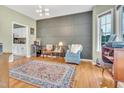Stylish living room featuring a decorative wall, modern lighting, and hardwood floors at 31 Bucking Saddle Way, Willow Springs, NC 27592