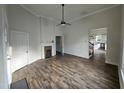 Cozy living room with wood-look floors, brick fireplace, and views into other living spaces at 310 E Woodall St, Smithfield, NC 27577