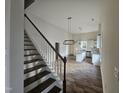 View of an open floor plan, stairs, and luxury vinyl plank flooring at 310 E Woodall St, Smithfield, NC 27577