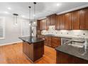 Well-equipped kitchen with wood cabinets, granite countertops, stainless steel appliances and island at 312 Bridgegate Dr, Cary, NC 27519