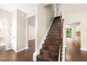 Elegant wooden staircase with modern design elements and natural light at 317 Chamberlain Dr, Clayton, NC 27527