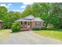 Quaint brick home featuring a well-kept lawn and a welcoming front entrance at 34 Johnston St, Pittsboro, NC 27312