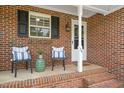 Close up of a inviting front porch with comfortable seating and decorative touches at 34 Johnston St, Pittsboro, NC 27312
