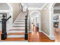 Stunning foyer featuring hardwood floors, staircase and beautiful archways at 3821 Falls River Ave, Raleigh, NC 27614