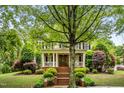 Charming two-story home featuring a welcoming front porch and meticulously maintained landscaping at 3821 Falls River Ave, Raleigh, NC 27614