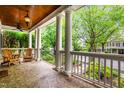 Relaxing front porch featuring lovely furniture, decorative concrete floor and scenic neighborhood views at 3821 Falls River Ave, Raleigh, NC 27614