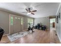 Open-concept living area with hardwood floors and an exercise bike at 4022 Avents Ferry Rd, Sanford, NC 27330