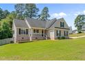 A delightful single Gathering home with great curb appeal and a well-maintained front lawn on a sunny day at 48 Arlington Dr, Cameron, NC 28326