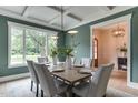 Elegant dining room featuring a coffered ceiling, modern lighting, and a large window at 4921 Sweetbriar Dr, Raleigh, NC 27609