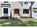 Close-up of a bright brick home with a dark roof and well-manicured landscaping at 4921 Sweetbriar Dr, Raleigh, NC 27609