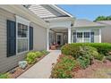 Inviting home featuring a covered porch with a seating area and manicured landscaping at 524 Clarenbridge Dr, Cary, NC 27519