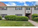 Charming townhouse featuring well-maintained landscaping, vinyl siding and green shutters at 5602 Falls Of Neuse Rd # E, Raleigh, NC 27609
