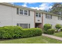 Inviting townhouse with vinyl siding, green shutters, and walkway entrance at 5602 Falls Of Neuse Rd # E, Raleigh, NC 27609