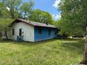 View of a home with blue siding, white trim, and a lush green lawn at 5644B Old Roxboro Rd, Oxford, NC 27565