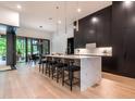 Modern kitchen with a large island, quartz countertops, sleek cabinetry, and stainless steel appliances at 661 Manchester Dr, Raleigh, NC 27609