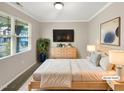 Cozy staged bedroom with neutral colors, large windows, and modern furnishings at 664 Lavenham Ln, Fuquay Varina, NC 27526
