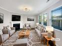Comfortable living room featuring neutral tones, a fireplace, and large windows at 664 Lavenham Ln, Fuquay Varina, NC 27526