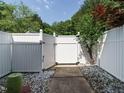 Backyard with a white fence and easy-to-maintain gravel provides a private outdoor space at 7408 Sandy Creek Dr, Raleigh, NC 27615