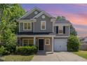Charming two-story home boasts a manicured lawn, attached garage, and inviting front entrance at 776 Averasboro Dr, Clayton, NC 27520