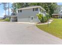 Side view of the house showing parking, a back door, and second story patio at 103 Rex Pl, Louisburg, NC 27549