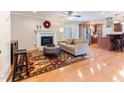 Cozy living room featuring a fireplace, hardwood floors, and open access to the kitchen at 103 Rex Pl, Louisburg, NC 27549