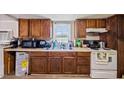Bright kitchen with essential appliances, wood cabinets, laminate countertops, and plenty of storage space at 105 E Cole St, Dunn, NC 28334