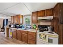 Functional kitchen space with light countertops, wooden cabinets, and an electric stovetop at 105 E Cole St, Dunn, NC 28334