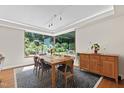 Bright dining room featuring a large window with a view of the lush backyard at 105 Juniper Ct, Carrboro, NC 27510