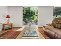 Cozy living room with a view to the landscaped backyard and comfortable seating at 105 Juniper Ct, Carrboro, NC 27510