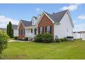 An eye-level side exterior view of a charming home with brick and vinyl siding at 1104 Cross Creek Dr, Nashville, NC 27856