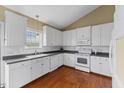 Bright kitchen with white cabinets, stainless steel appliances, and hardwood floors at 1104 Cross Creek Dr, Nashville, NC 27856