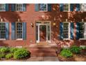 Inviting front entrance of a red brick home with a decorative wreath on the front door at 113 Wilander Dr, Cary, NC 27511