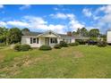 A quaint, single-story home with lush landscaping, offering a serene and inviting curb appeal at 1169 Clayhole Rd, Dunn, NC 28334
