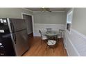 Cozy dining room with wood floors, a glass table, and stainless steel refrigerator at 1223 Wallace St, Burlington, NC 27215