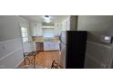 Kitchen featuring white cabinets, stainless steel appliances and wood floors at 1223 Wallace St, Burlington, NC 27215