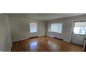 Bright living room featuring hardwood floors, large windows, and neutral walls at 1223 Wallace St, Burlington, NC 27215