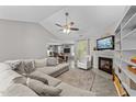 Spacious living room with vaulted ceiling, fireplace, and a view of the eat-in kitchen at 123 Terawood Farm Dr, Willow Springs, NC 27592