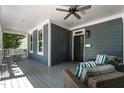 Relaxing front porch with a swing, cushioned seating, and a ceiling fan, perfect for outdoor enjoyment at 1313 Dale St, Raleigh, NC 27605