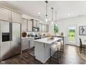 Modern kitchen with stainless steel appliances, a center island with seating, and plenty of cabinet space at 140 Camel Crazies Pl # 39, Lillington, NC 27546