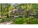 Beautiful home surrounded by lush greenery and mature trees at 191 Nc 56, Louisburg, NC 27549