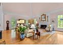 Bright living room featuring a fireplace, hardwood floors, and elegant decor at 191 Nc 56, Louisburg, NC 27549