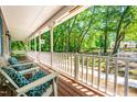 Inviting covered porch with comfortable seating and a view of the beautifully landscaped front yard at 2100 Fort Dr, Clayton, NC 27520
