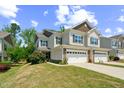 Charming townhome showcasing a well-kept lawn and neutral siding, perfect for low-maintenance living at 221 Mayfield Dr, Apex, NC 27539
