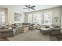 Comfortable living room featuring ample seating, neutral colors, and large windows for natural light at 221 Mayfield Dr, Apex, NC 27539