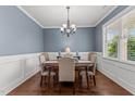 Traditional dining room featuring hardwood floors, a chandelier, and a window view of the outdoors at 24 Sweet Birch Row, Youngsville, NC 27596