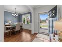 Traditional dining room featuring hardwood floors, a chandelier, and a window view of the outdoors at 24 Sweet Birch Row, Youngsville, NC 27596