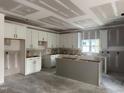 Spacious kitchen featuring white cabinets, a large island, and a window providing ample natural light at 240 Green Pines Estates Dr, Kenly, NC 27542