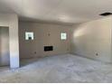 Unfinished living room with new drywall, concrete floor, and two windows for plenty of natural light at 240 Green Pines Estates Dr, Kenly, NC 27542