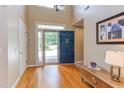 Bright foyer with hardwood floors, a high ceiling, and a blue front door, offering a grand entrance to the home at 313 Helmsdale Dr, Chapel Hill, NC 27517