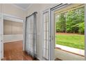 Hallway featuring hardwood floors with views of the backyard and an adjacent room at 3653 Range Rd, Stem, NC 27581